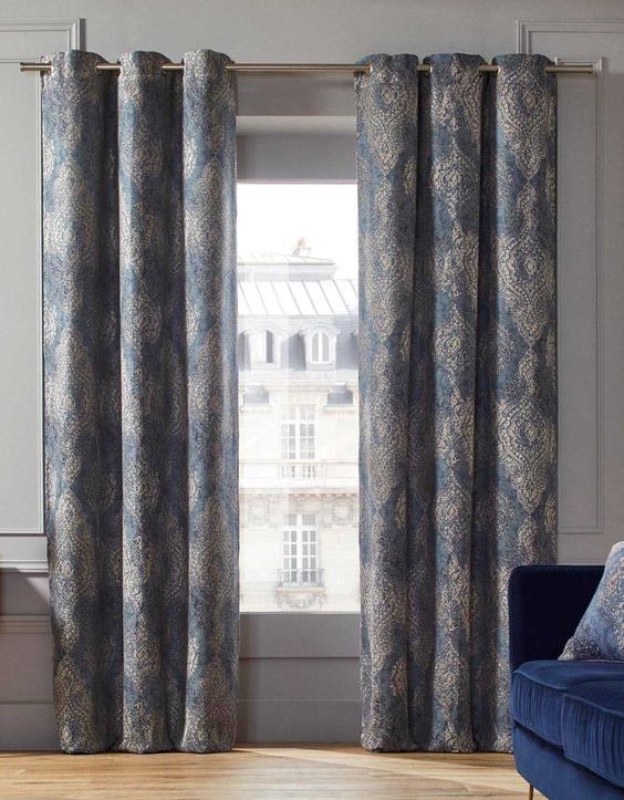 Long white curtains with blue motifs