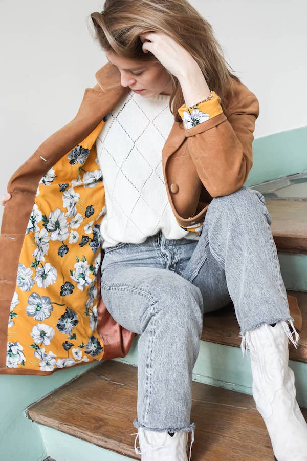 Brown leather coat lined with yellow fabric with white flowers