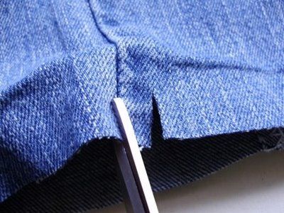 Cutting the bottom of a pair of jeans