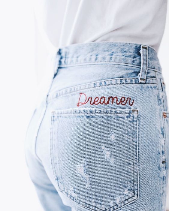 Embroidery above a jeans pocket