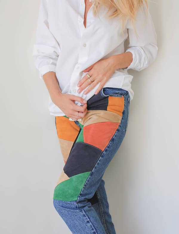 Upcycled jeans using a patchwork of multicoloured leathers