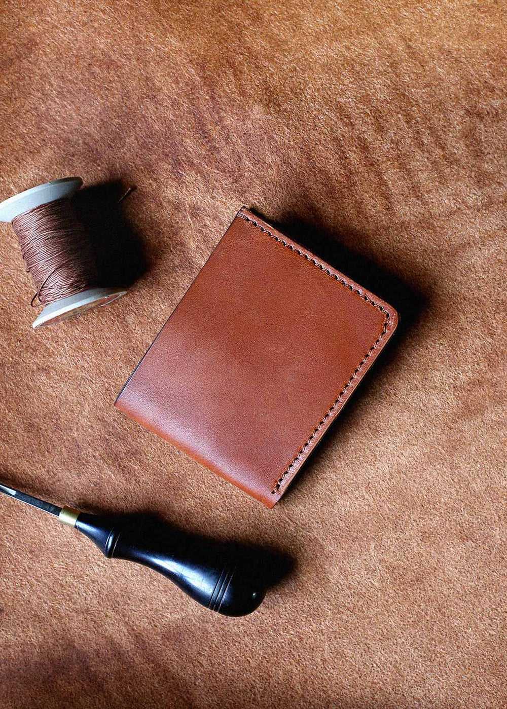Our leather craftsmen repair your wallet.